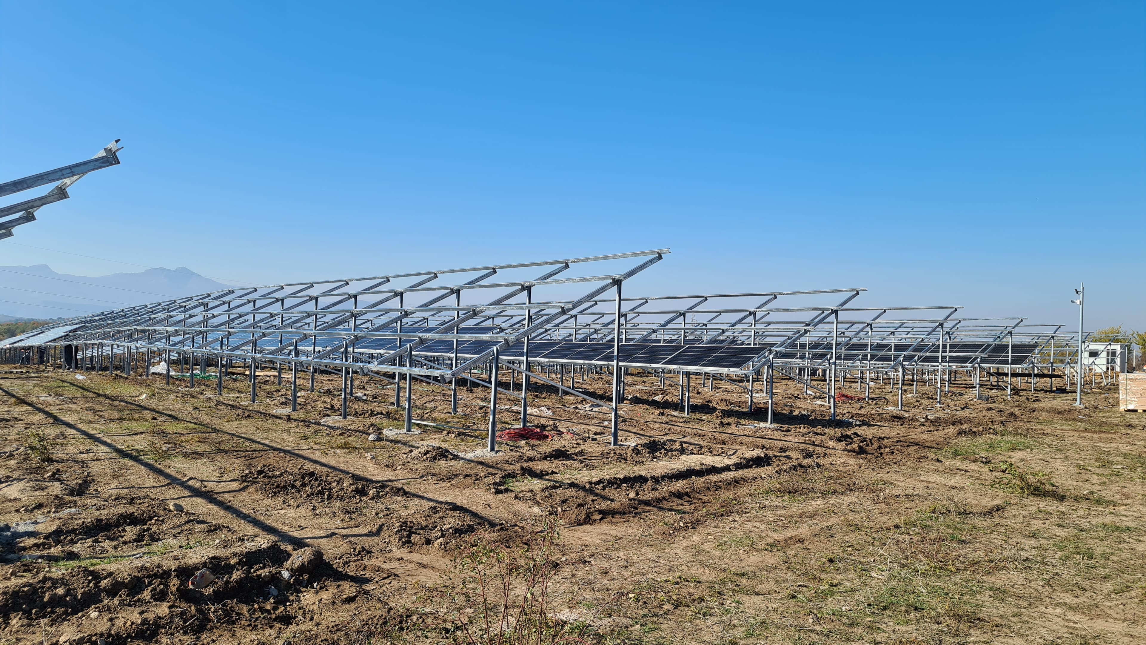 Construction site with solar panel mounting structures being built
